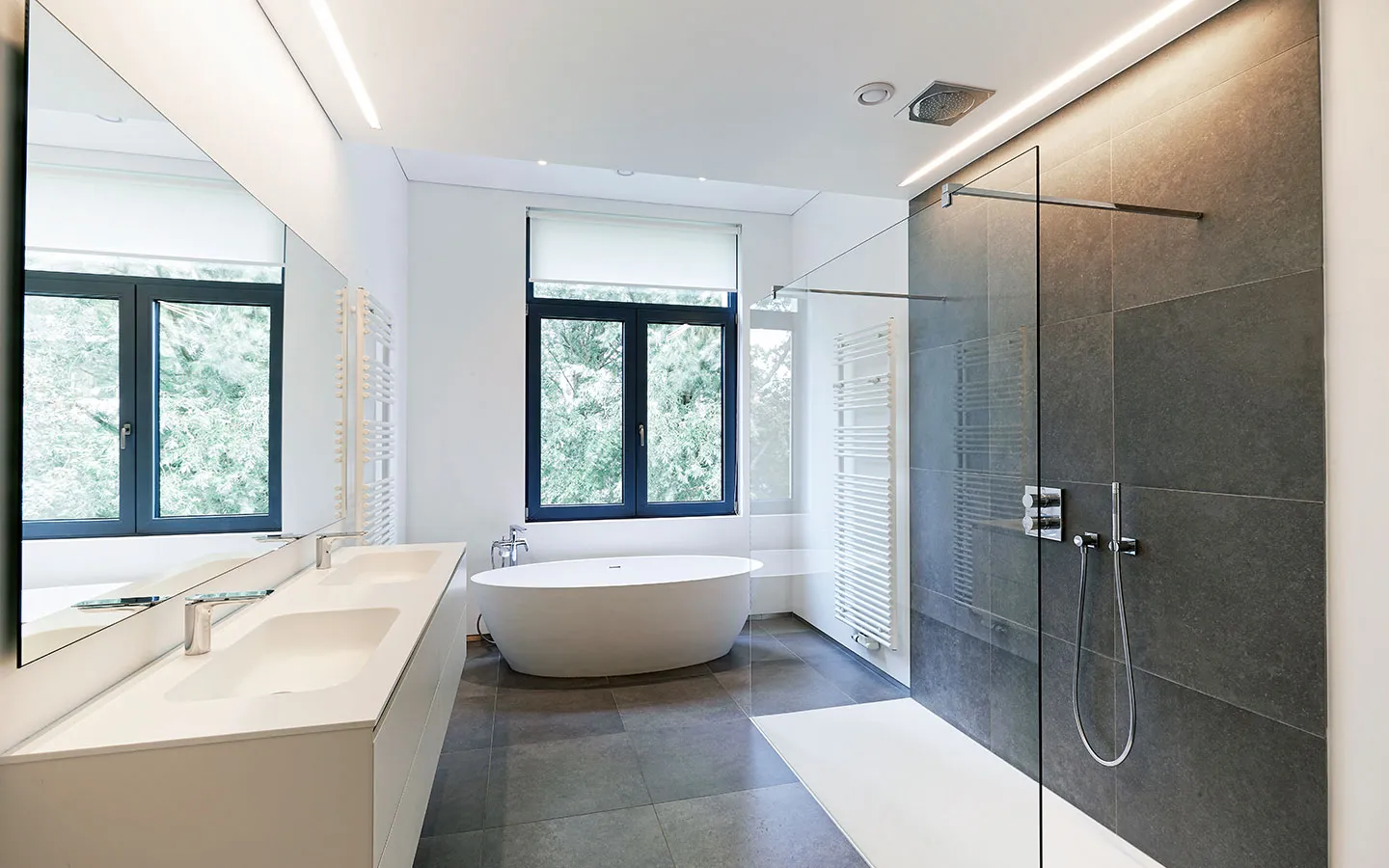 Bathroom with white plantation shutters beside a spa bath