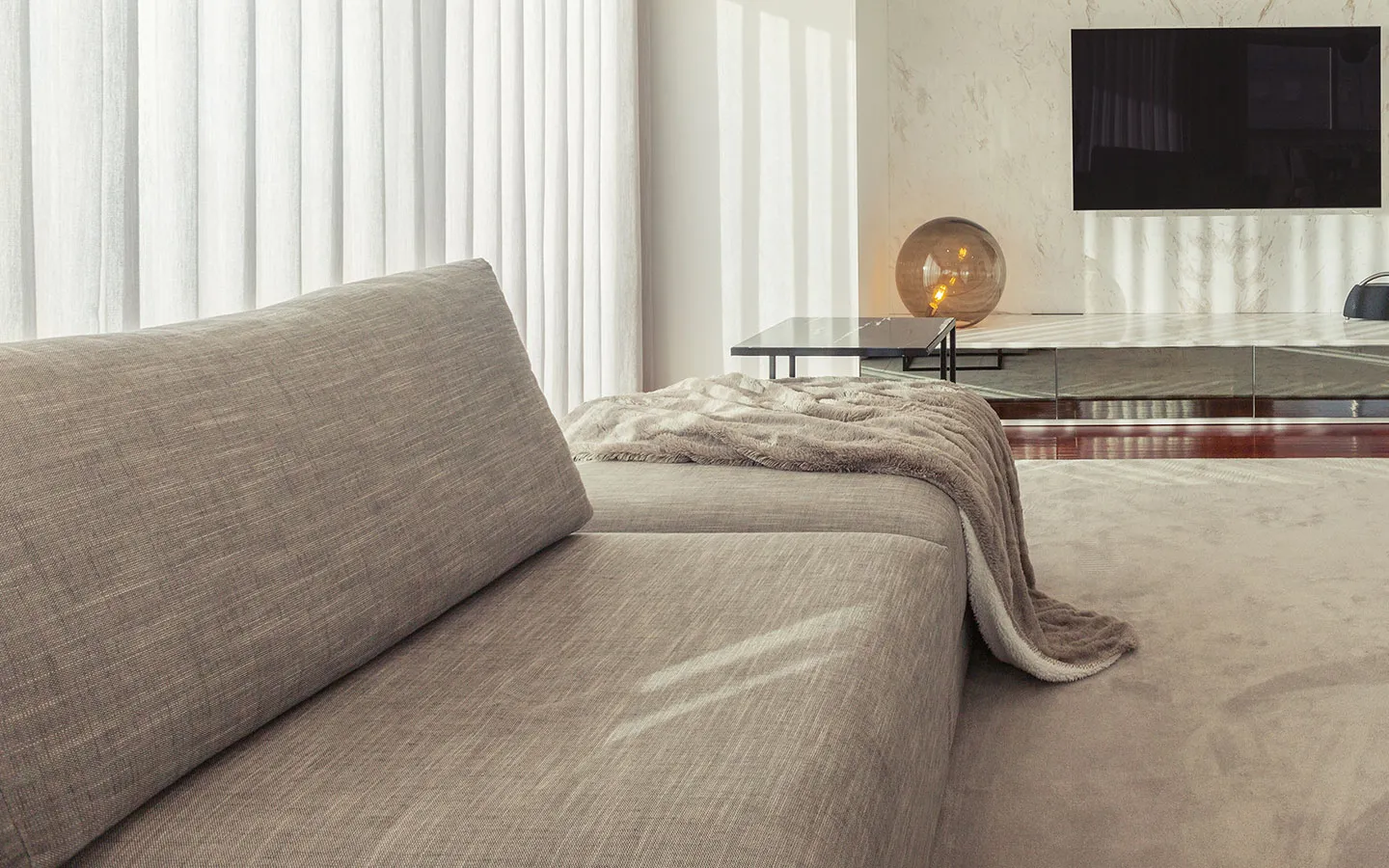 Bed with white pillows and grey herringbone cushions